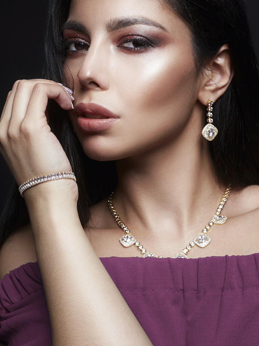 A woman in a purple dress wearing a necklace and earrings